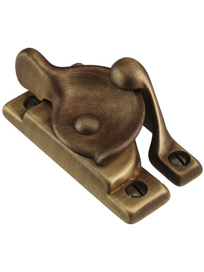 Solid-Brass Crescent Sash Lock in Antique Brass.